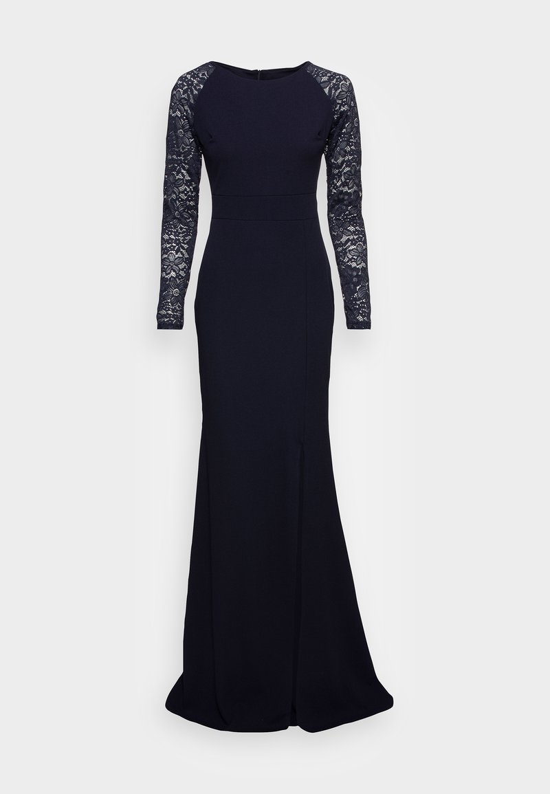 Tumši zils garais kleitas piedurknes ar mežģīņu piedurknēm, pieguļošs korpuss un ar platāku svārku, kam priekšā ir diskrēts šķēlums.