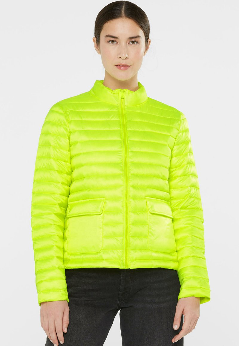 Bright green puffer jacket with a high collar, zip closure, and two front pockets. Lightweight, quilted texture with a shiny finish.