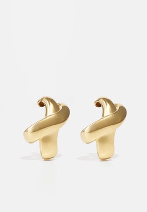 Gold-tone metal earrings featuring a fluid, twisted design with a glossy finish and a small loop at the top for attachment.