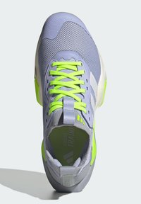 Gray training shoe with a mesh upper, bright green laces, and a cushioned sole. Features logo accents and a padded heel for support.