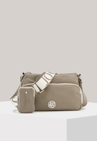 Beige crossbody bag made of smooth material, featuring a logo, patterned strap, and a small attached pouch with a zip closure.