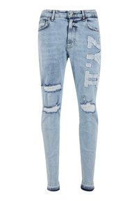 Heledad sinine teksariie, millel on kulumisjäljed ja trükitud tekst ees. Omab klassikalist viit tasku ja nupule suletavat esiosa.