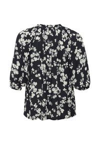 Blouse noire à fleurs avec des motifs blancs, dos plissé et manches courtes bouffantes. Tissu léger, coupe décontractée, adaptée pour un usage casual.