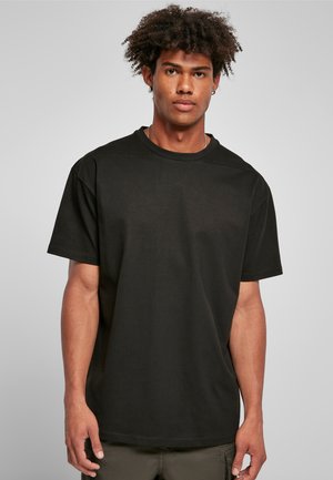 Black short-sleeve t-shirt made of cotton, featuring a crew neckline and relaxed fit, with visible stitching details.