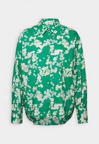 Chemise verte à manches longues avec un motif floral abstrait blanc et un col classique.