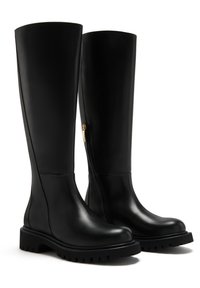 Black leather knee-high boots with a rounded toe, side zipper, and textured rubber sole featuring deep grooves for traction.