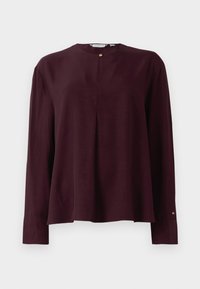 Long-sleeve dark burgundy blouse with a round neckline, front pleat, and single gold button closure at the neck.