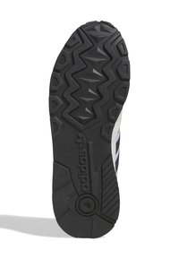 Talpa de cauciuc neagră cu model texturat în zigzag, având un accent alb și un logo embossat pe lateral.