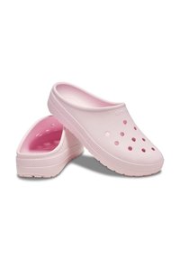 Pink clogs with a smooth, matte finish and ventilation holes on the sides, featuring a flexible design and textured outsole for grip.