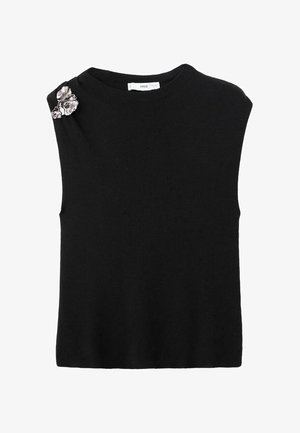 Top sans manches en tricot noir avec un col rond et une broche florale décorative sur l'épaule gauche. Texture douce et coupe ajustée.