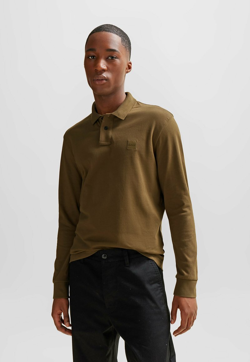 Lange mouw polo shirt in donker olijfgroen katoen met een opstaande kraag, een sluiting met één knoop en een klein vierkant logo op de borst.