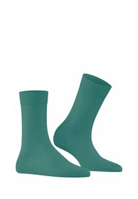 Türkise Baumwollsocken mit gerippten Bündchen. Knöchellanges Design mit einer glatten Textur und gleichmäßiger Färbung.