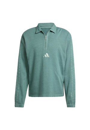 Groene rits-pullover met lange mouwen, gemaakt van zachte stof. Kenmerkt zich door een minimalistisch ontwerp, met een subtiel logo op de borst en getextureerde manchetten.