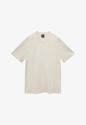 Ljusbeige kortärmad t-shirt i mjukt material, med rund halsringning och rak fåll. Enkelt och enfärgat mönster utan dekorationer.