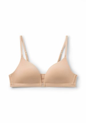 Bežová bezdrátová podprsenka s bezešvými tvarovanými košíčky, nastavovacími ramínky a hladkým povrchem. Má minimalistický, klasický design.