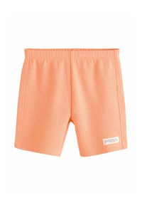 Persikofärgade shorts med ett strukturerat, våffelliknande mönster. Utrustade med en elastisk midja och en liten etikett på framsidan.