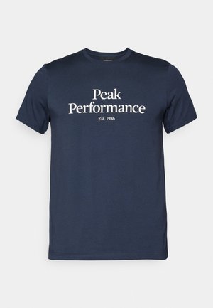 Navy blue cotton t-shirt with short sleeves, featuring white text "Peak Performance" and "Est. 1986" centered on the front.