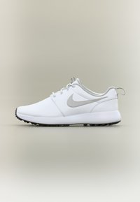 White athletic shoes with a smooth upper, gray Nike logo, and a textured black sole. Features lace-up design and cushioned midsole.