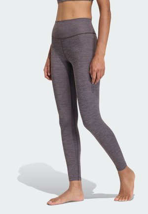 High-waisted gray leggings made from a textured, stretchy fabric. Features a smooth waistband and fitted leg design.