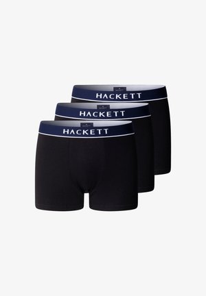 Tre boxer neri con fascia in vita blu navy con testo bianco "HACKETT", impilati su uno sfondo bianco.