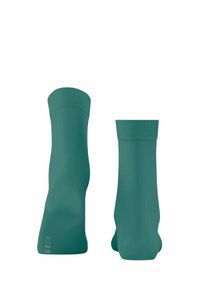 Türkise Crew-Socken aus glattem, elastischem Material. Mit einem gerippten Bündchen oben und einem glatten Schaft, der eine verstärkte Zehen- und Fersenpartie hat.