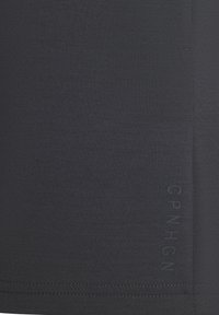 Dark gray, stretchy fabric with a smooth texture. Features a subtle embossed brand logo along the side and clean stitching along the hem.