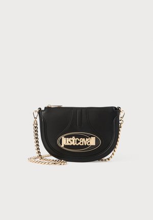Black leather shoulder bag with a gold-tone chain strap and a prominent oval logo accent. Rounded shape with stitched details on the front.