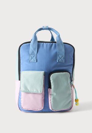 Zaino con manici azzurri, corpo principale blu, due tasche frontali in rosa pastello e verde chiaro e una piccola linguetta gialla per la cerniera.