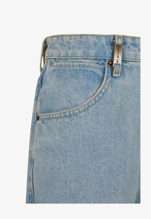 Light blue denim jeans featuring a high waist, front pocket, yellow stitching, and a metal tag on the waistband.