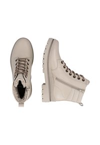 Beige leather ankle boots featuring a rugged white sole, decorative laces, and a side zipper for easy access. Cozy lining visible inside.