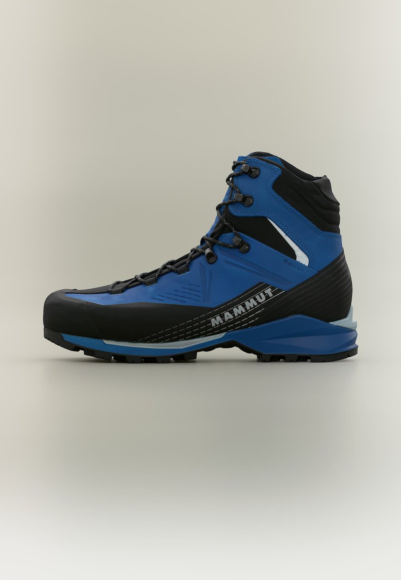 Μπλε και μαύρο μποτάκι πεζοπορίας Mammut με ψηλή γλώσσα, κορδόνια, ενισχυμένη μύτη, μαξιλαρωμένος αστράγαλος και ανθεκτική σόλα για χρήση σε εξωτερικούς χώρους.