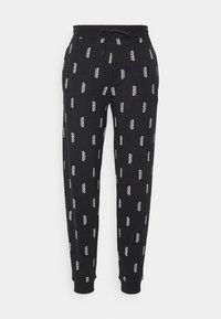 Zwarte sweatpants van een katoenmix, met een overal wit logo-patroon, elastische tailleband met trekkoord en rib gebreide manchetten.
