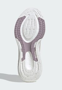 Shoe sole features a textured, white rubber base with light purple accents and a patterned tread for traction. Visible brand details included.