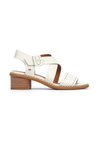 White leather heeled sandal with crisscross straps and a side buckle. Features a lightweight brown wooden heel and decorative stitching.
