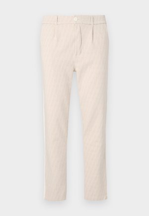 Beežid mustrilised püksid, millel on õrn lehemuster, hästi lõigatud, nööbikinnitusega ja küljetaskutega. Sile kangapind.