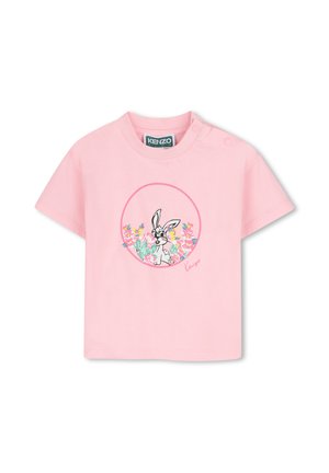 T-shirt bébé rose à manches courtes avec un lapin cartoon entouré de fleurs colorées à l'intérieur d'un cercle rose sur le devant.