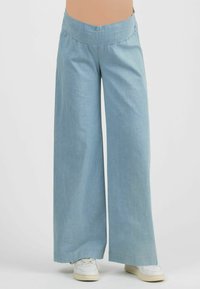 Light blue, wide-leg pants with a smocked waistband. Made of soft fabric, featuring a relaxed fit and straight hem. Paired with white sneakers.