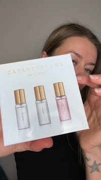 ZARKOPERFUME Triple Treat set in white box features three glass bottles: clear, silver, and pink, each with gold caps, displaying scent names.