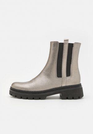Metallic silver Chelsea boot with elastic side panels, rounded toe, and chunky black sole. Smooth texture with a slightly matte finish.