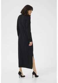 Black long-sleeve dress with a straight silhouette and side slit. Made from smooth fabric, features a round neck and fitted cuffs.
