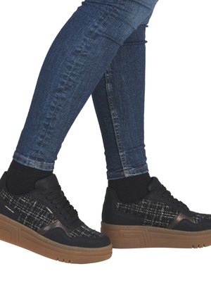 Black sneakers with textured fabric upper in a check pattern, featuring a brown platform sole and black laces. Mid-top design, sleek profile.