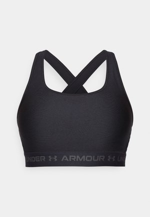 Soutien-gorge de sport noir avec des bretelles croisées, fabriqué en tissu lisse. Présente une bande élastique avec "UNDER ARMOUR" en lettres grises le long du bas.