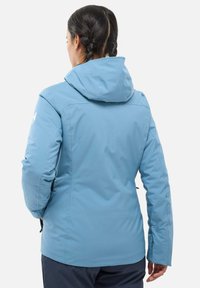 Light blue winter jacket with a hood, zippered pockets, and long sleeves. Textured, water-resistant material. Back view.