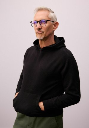 Black hooded sweatshirt with a front pouch pocket. Made from soft fabric, featuring a relaxed fit and ribbed cuffs.