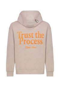 Beige hoodie with a drawstring hood. Back features large orange text: "Trust the Process" and "Great Times." Small graphic on the hood's corner.