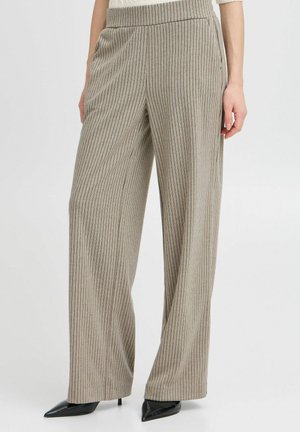 Wide-legged, ribbed trousers in beige with thin vertical black stripes. Features a high elastic waistband and side pockets.