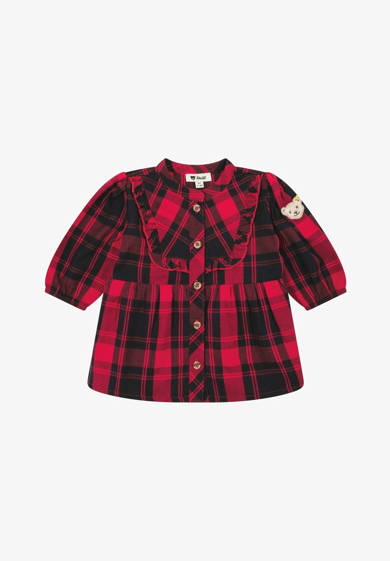 Rotes und schwarzes Karomusterkleid mit langen Ärmeln, Rüschendetail auf der Vorderseite und Bären-Aufnäher am linken Ärmel. Mit Knopfverschluss.