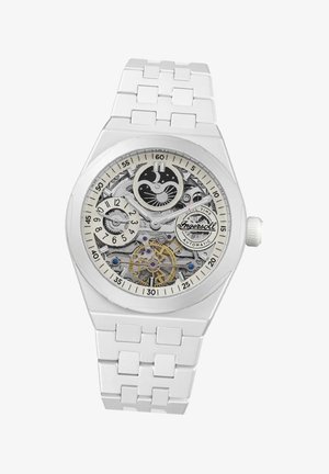 Witte polshorloge met transparante skeletdial, zilveren tandwielen en gouden accenten. Heeft een gladde witte band en een ronde kast.