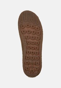 Brown shoe sole with circular and rectangular treads, textured surface, and "Camper 42" logo near the heel on a plain background.