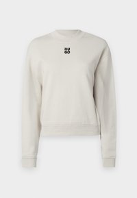 Sudadera beige claro con cuello redondo, mangas largas, puños de canalé y un pequeño logo negro "HUGO" en el pecho. Material suave.